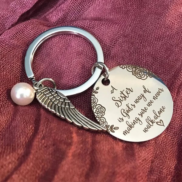 LAST DAY 49% OFF - A Sister is God's Way of Making Sure We Never Walk Alone Keychain