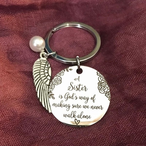 LAST DAY 49% OFF - A Sister is God's Way of Making Sure We Never Walk Alone Keychain