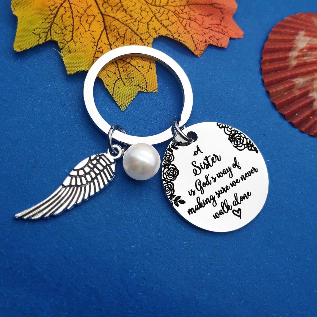 LAST DAY 49% OFF - A Sister is God's Way of Making Sure We Never Walk Alone Keychain